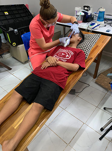 The dentist is checking the patient's teeth